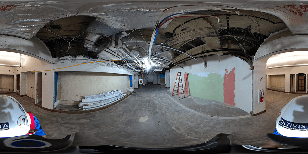 A panoramic view showing carpet removal as well as removal of old lighting and prep work for installation of new lighting.