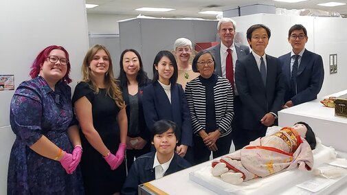 Visitors from the Japanese consulate pose by Miss Mie with members of the UNSM anthropology collection and UNSM director. 