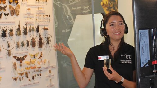 An educator talks to students with remote technology about insects. 