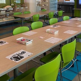 Long table set up with paper activities