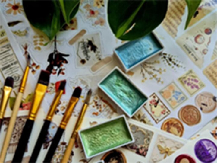 Art supplies with plants and other natural history images underneath.