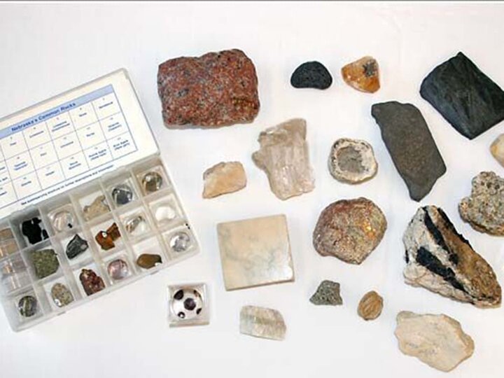 A display of various rocks and minerals on a table. 