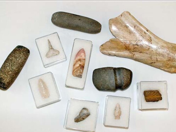Arrowheads and stone mortars on display.